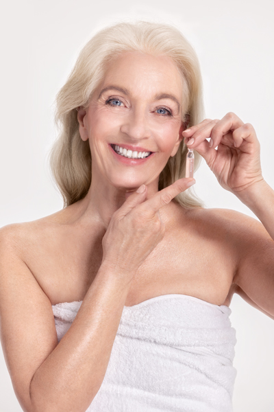 Our ampoules are available in sets as a practical weekly treatment. mature woman with ampoule concentrate in her hands